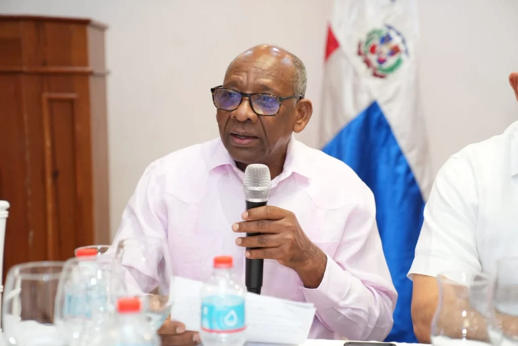 Félix Santos habla con micrófono en la mesa principal